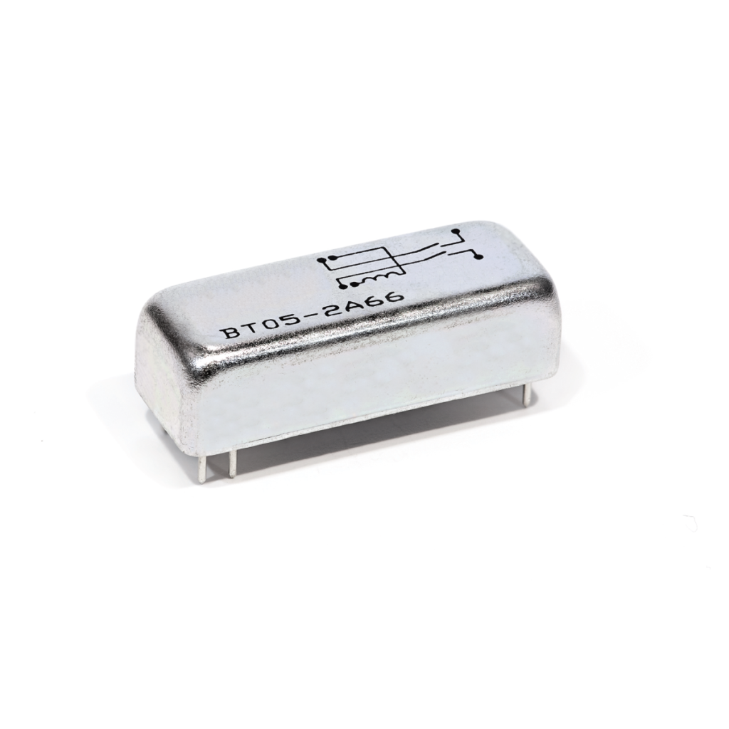 A rectangular, silver-colored Reed Relay electronic component with four pins and a circuit diagram on top, labeled BT05-2466, isolated on a white background. by Standex Detect