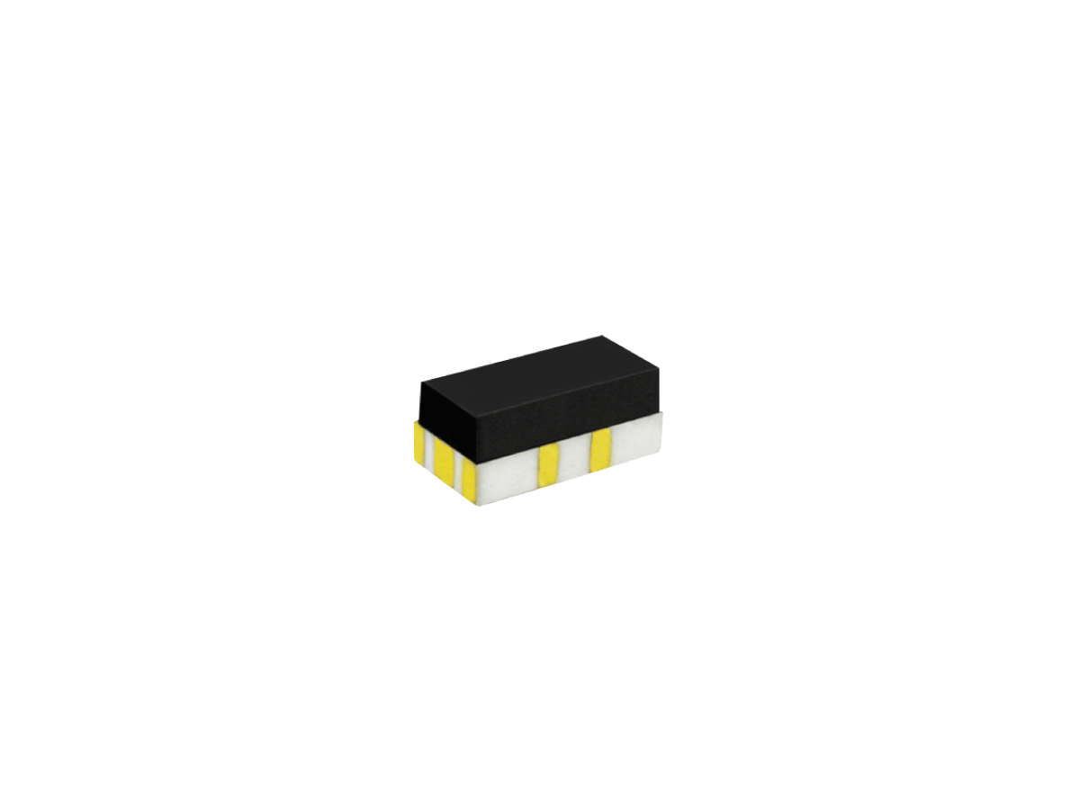 A small black rectangular electronic component from the CRF Series with a white base and four yellow metallic contacts, pictured against a plain white background. by Standex Detect