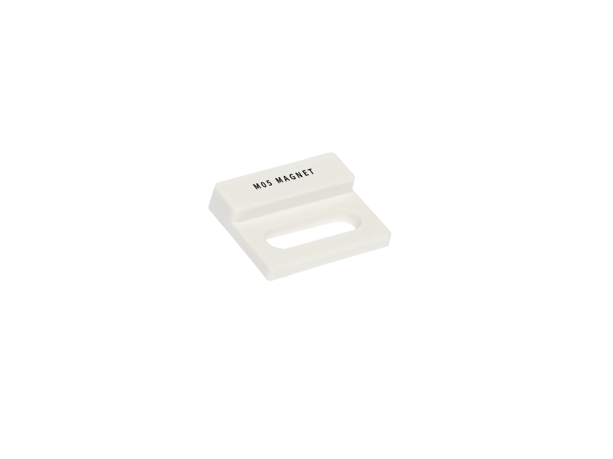 A small white rectangular object labeled MDS MAGNET, featuring a slotted opening in the center, is shown on a plain white background. This appears to be part of the M05 Series Magnet. by Standex Detect