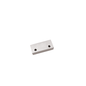 A small rectangular metallic block from the M27 Series Magnet line, featuring two circular holes side by side on its surface, placed against a plain white background. by Standex Detect